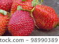 Ripe strawberries on a wooden board 98990389