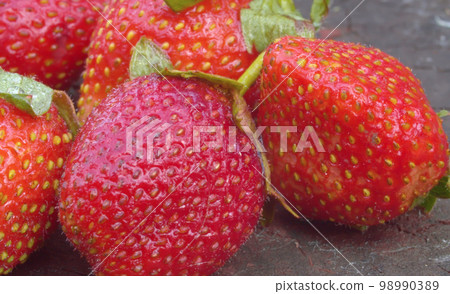 Ripe strawberries on a wooden board Ripe strawberries on a wooden board 98990389