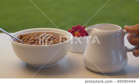 Bowl of cornflakes and raspberry 98990404