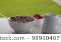 Bowl of cornflakes and raspberry 98990407