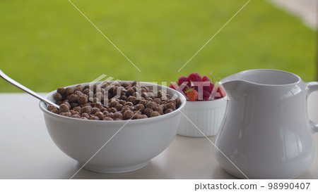 Bowl of cornflakes and raspberry Bowl of cornflakes and raspberry 98990407