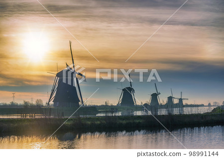 Rotterdam Netherlands, sunrise nature landscape of Dutch Windmill at Kinderdijk Village 98991144