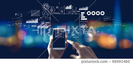 Eco theme with person using a smartphone at night 98991460
