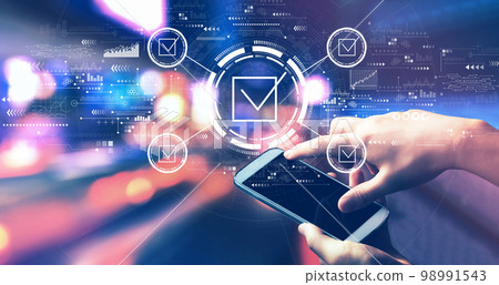 Checklist concept with person using a smartphone at night 98991543