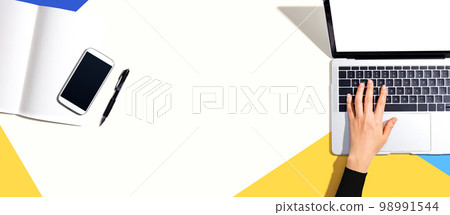 Person using a laptop computer 98991544