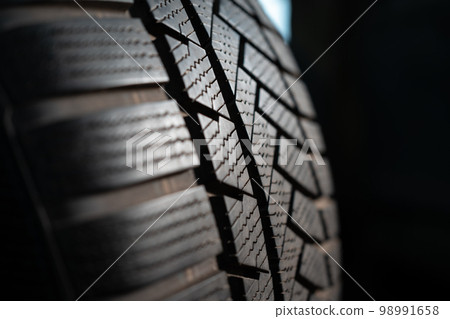 new car tire on black background 98991658