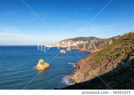 Rocky Cliffs on the Sea Coast. Sardinia, Italy. 98991835