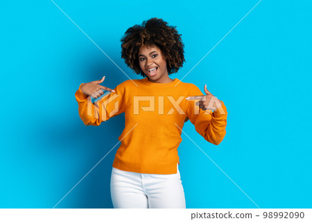 Cool pretty young black lady pointing at herself Cool pretty young black lady pointing at herself 98992090