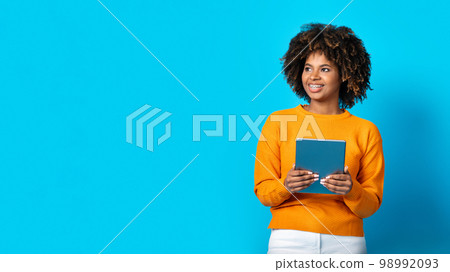 Positive african lady holding digital tablet, copy space 98992093