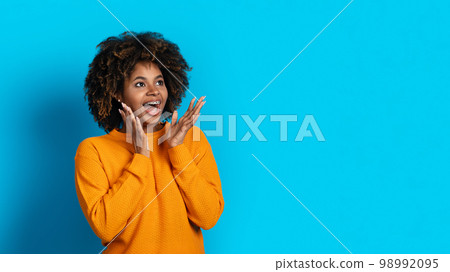 Excited young african lady looking at copy space 98992095