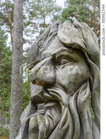A fragment of a wooden sculpture of a forest deity in the Siberian forest A fragment of a wooden sculpture of a forest deity in the Siberian forest 98992544