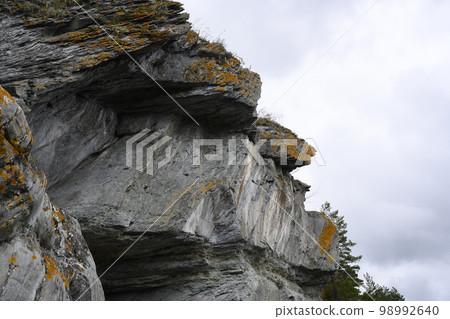 Rock in form of a human head with carved petroglyphs dated 35-1 centuries BC on Tom River in Siberia Rock in form of a human head with carved petroglyphs dated 35-1 centuries BC on Tom River in Siberia 98992640