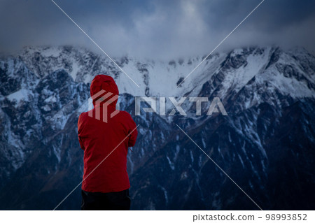 A man looking at Mount Hotaka in the Northern Alps 98993852