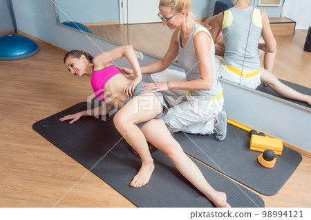 Woman stretching and relaxing in physical therapy exercise Woman stretching and relaxing in physical therapy exercise 98994121