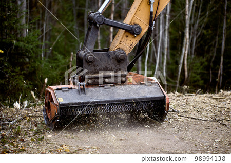Excavator mulching head is forestry mulcher for clears vegetation of road side. Excavator mulching head is forestry mulcher for clears vegetation of road side. 98994138