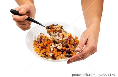 Female eating healthy raw food breakfast bowl on isolated background 98994479