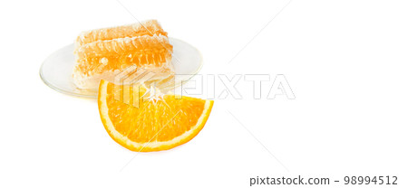 Honeycomb and orange slice isolated on white. Free space for text. Wide photo. Honeycomb and orange slice isolated on white. Free space for text. Wide photo. 98994512