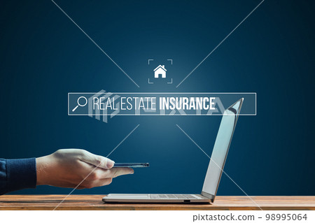 Person works on smartphone and laptop. Looking for insurance on the Internet for real estate. Risk of an earthquake. Person works on smartphone and laptop. Looking for insurance on the Internet for real estate. Risk of an earthquake. 98995064