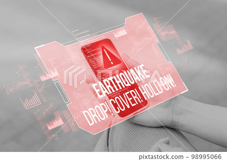 A person is holding a smartphone with an abstract earthquake notification and need to be saved. A person is holding a smartphone with an abstract earthquake notification and need to be saved. 98995066