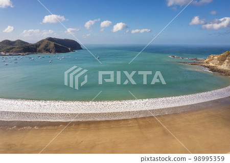 Empty exotic beach on blue water bay 98995359