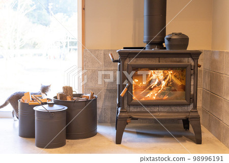 A wood-burning stove on the earthen floor, sometimes a cat A wood-burning stove on the earthen floor, sometimes a cat 98996191