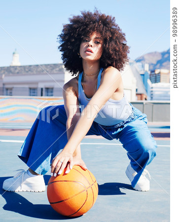 Portrait, fashion and basketball with a black woman outdoor on a sports court for urban or street style. City, fitness or style and an attractive young female posing outside with a ball for lifestyle 98996389
