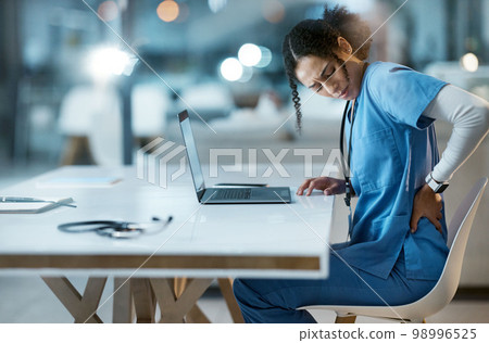 Back pain, stress and doctor in her office at the hospital working on a diagnosis or cure. Computer, healthcare and female medical worker with a muscle sprain, ache or inflammation at medicare clinic 98996525