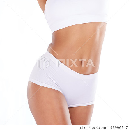 Health, diet and stomach, woman with tummy tuck, skinny waist and isolated on white background. Fitness, healthcare and wellness, slim figure girl after liposuction or weight loss workout in studio. 98996547