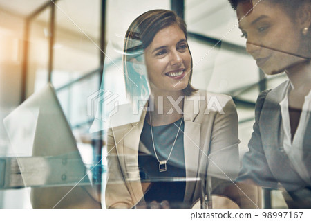 Business women, laptop and discussion planning tech strategy, marketing meeting or happy teamwork collaboration. Business people, web design and ux designers development on digital device in office Business women, laptop and discussion planning tech strategy, marketing meeting or happy teamwork collaboration. Business people, web design and ux designers development on digital device in office 98997167