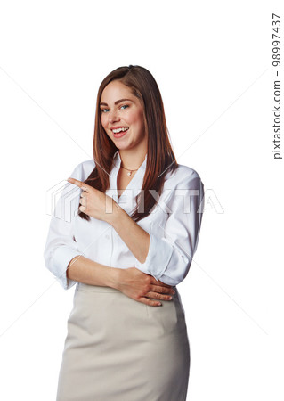 Showing, displaying and pointing at copy space by businesswoman isolated in a studio white background. Happy, excited and smiling corporate female presenting promo deal with her finger 98997437