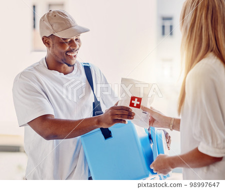 Healthcare, delivery and supply with a courier black man making a delivery to a woman in her home. Medical, shipping and service with a male in a house to deliver a package to a female customer 98997647