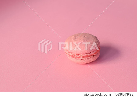 A pink macaroon on a minimalistic pink background 98997982