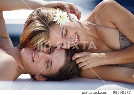 Yacht, couple and love on a boat with summer bikini and smile outdoor in the sun. Happy, date and vacation care of a woman and man together on holiday together with happiness in sunshine outside 98998177