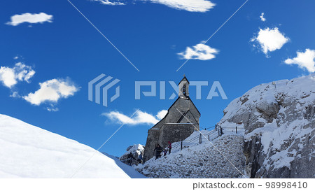 small old church on mountain. Beautiful alpine mountains in winter. Bayrischzell, Bavaria, Germany. small old church on mountain. Beautiful alpine mountains in winter. Bayrischzell, Bavaria, Germany. 98998410