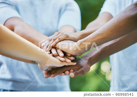 People, diversity and hands together for community, trust or collaboration in partnership in the outdoors. Hand of team piling or joining in unity for agreement, coordination or support in solidarity 98998541