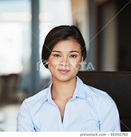 Portrait, young and Asian business woman working in a modern office and smiling. Happy, confident and female entrepreneur or insurance professional in Bangkok on a webcam at a company 98998760