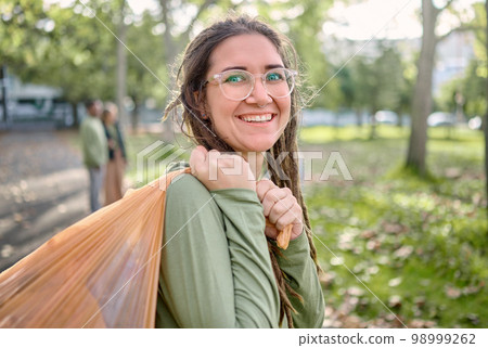 Plastic bag, park and happy woman for eco friendly cleaning on earth day, community service or volunteering support. Recycle, trash or garbage of ngo person in portrait for nature or forest pollution Plastic bag, park and happy woman for eco friendly cleaning on earth day, community service or volunteering support. Recycle, trash or garbage of ngo person in portrait for nature or forest pollution 98999262