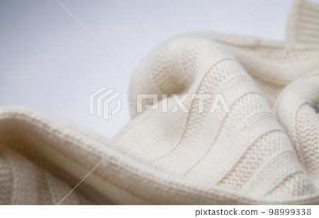 Texture of the fabric of a winter sweater Texture of the fabric of a winter sweater 98999338