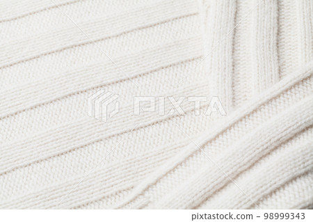 Texture of the fabric of a winter sweater Texture of the fabric of a winter sweater 98999343