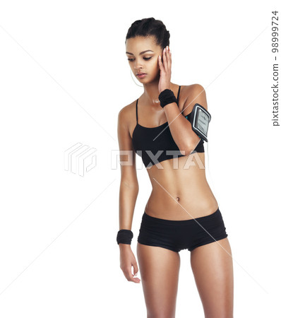 Music, fitness and sports with woman and phone for workout, health and cardio training. Podcast, mobile radio and motivation with isolated girl listening to earphones for exercise, streaming and goal 98999724