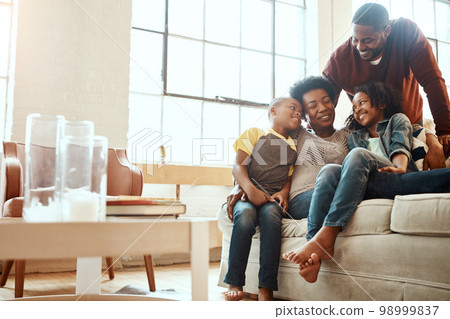 Love, black family and playful in living room, couch and bonding for quality time, loving and break. Mother, father and children on sofa in lounge, happiness and smile on weekend, playing and relax 98999837