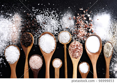 Colorful mix of salt varieties: sea and black, table and pink, himalayan and celtic. Food ingredients on dark background Colorful mix of salt varieties: sea and black, table and pink, himalayan and celtic. Food ingredients on dark background 98999853