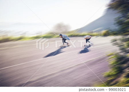 Skateboard, fast and people on road training, competition or danger, risk and adventure sports, above. Speed, blurred background and skater team moving on street for youth energy, balance and action 99003021