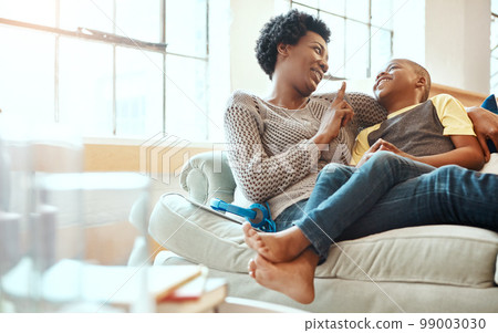 Black family, son and mother relax on a sofa, laugh and happy while bond in their home together. Mom, love and boy resting with parent, content and playful while sitting and talking in living room Black family, son and mother relax on a sofa, laugh and happy while bond in their home together. Mom, love and boy resting with parent, content and playful while sitting and talking in living room 99003030