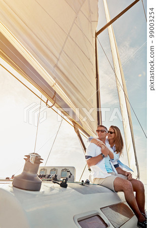 Travel, investment and luxury with couple on yacht for success, relax and wealth on retirement trip. Rich, love and ship hobby with baby boomers man and woman sailing on boat for tropical vacation 99003254