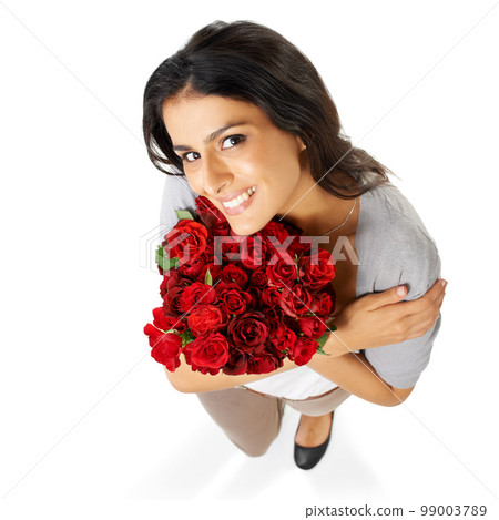 Above, portrait and woman with rose in studio for love, romance and valentines day on white background space. Happy, smile and bouquet for indian girl face hug floral, gesture and romantic isolated 99003789