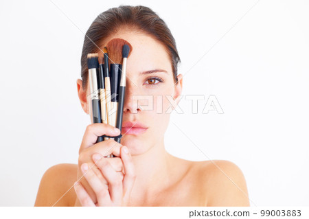 Woman, face and makeup tools in portrait, beauty and cosmetics isolated on white background. Mockup space, female in studio with cosmetic brush in hands and skincare, dermatology glow and wellness 99003883