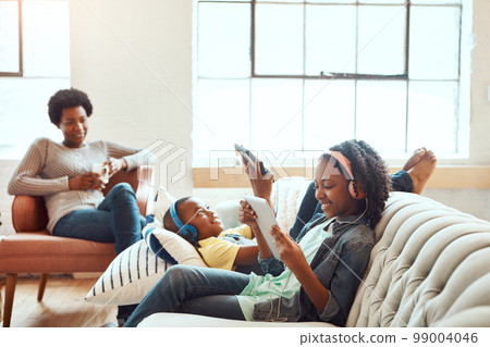 Tablet, relax and black family children, mother or African people relax together, bond and enjoy quality time. Love, digital tech and youth kids listening to music, streaming video or online gaming 99004046