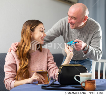 Husband giving plastic card to his wife 99004481