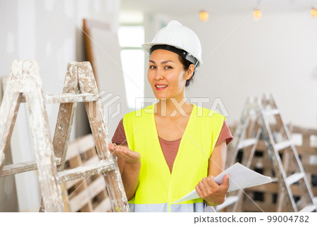 Woman construction worker with project documentation Woman construction worker with project documentation 99004782